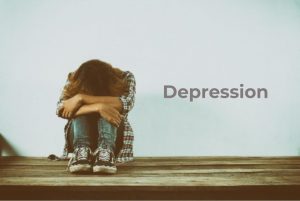 A person sitting on a bench with a thoughtful expression, symbolizing depression, with a bright light in the background representing hope and healing through homeopathy